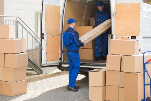 Man and van loading furniture in Bermondsey near local residential buildings