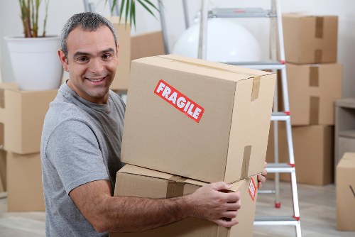 Removal crew handling furniture in a Bermondsey flat move