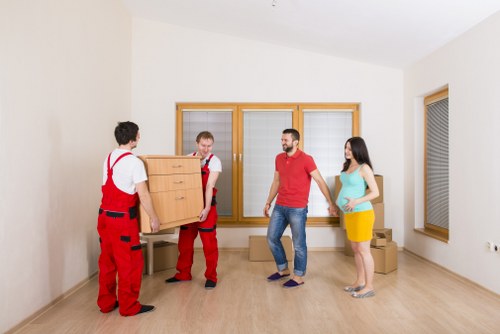 Movers preparing boxes and equipment with safety checks before lifting