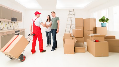 Removals team handling furniture in a Bermondsey residential street